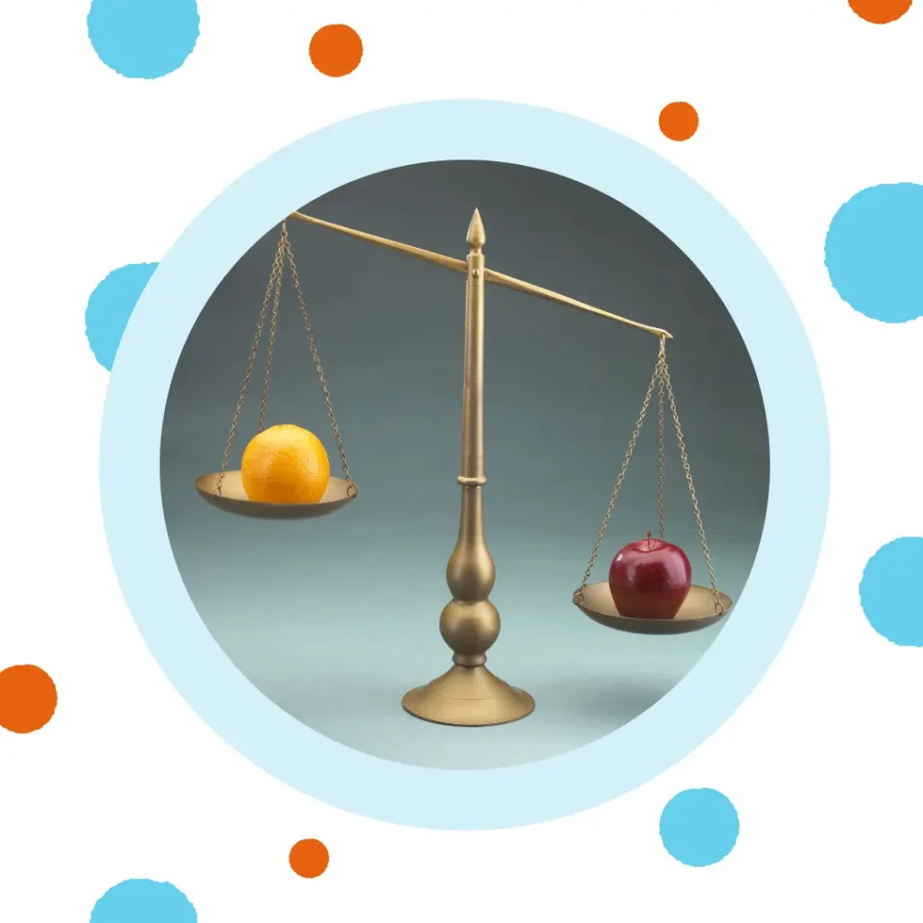 A balance scale shows an orange and an apple, with the orange higher.