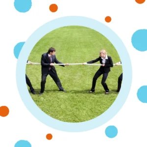 People in business suits play tug of war on a field. 
