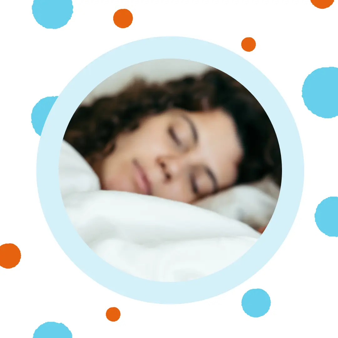 A woman sleeps in her bed.