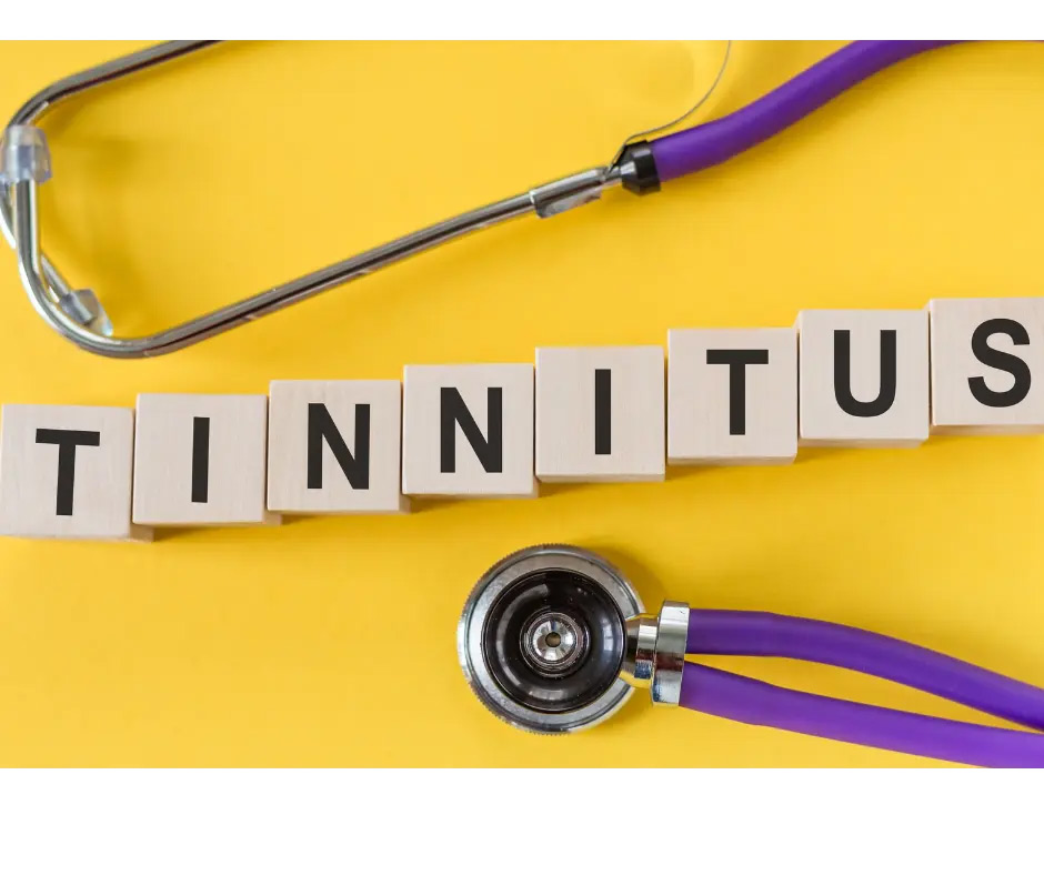 The word “tinnitus” is spelled out with letter tiles on a yellow background.