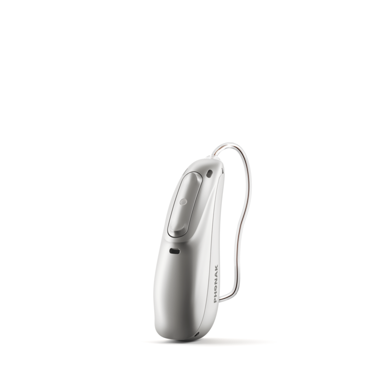 A silver Phonak Audeo Lumity hearing aid stands on a white background. 