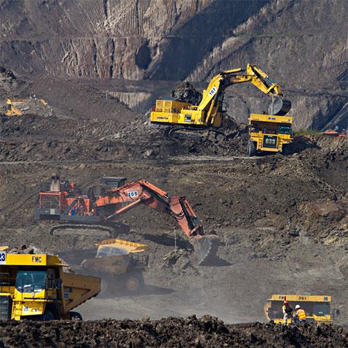 Mining operations with very large, loud machinery that puts workers hearing at risk without proper hearing protection.